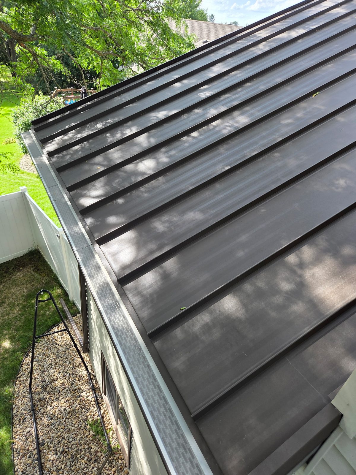 Guard runs fitted tight along a metal roof eave